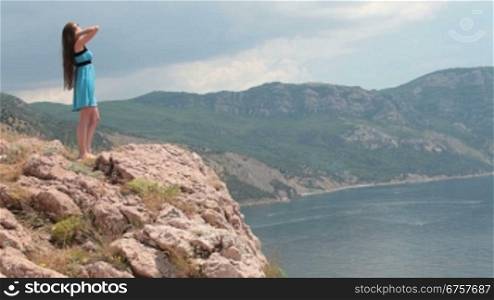 a young woman standing on a rock by the sea Balaklava, Crimea