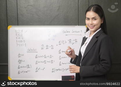 A young woman teacher is using a camera for recording online lesson during quarantine, online education , distance learning concept. 