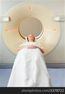A young woman undergoing a CT scan in a hospital