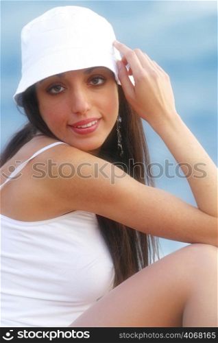 A young woman wearing white at the beach.