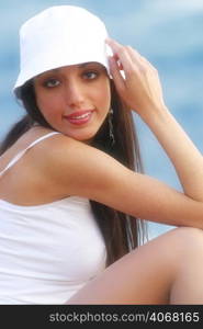 A young woman wearing white at the beach.