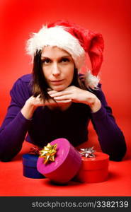 A young woman with a present isolated on red