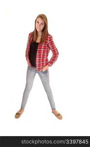 A young woman with long brunette hair standing in the studio in jeansand a checkered red shirt, for white background.