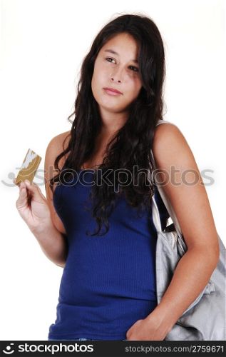 A young woman with long brunette hair, thinking to spend or not, with hercredit card in her hand and a bag over her shoulder, for white background.