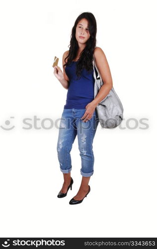 A young woman with long brunette hair, thinking to spend or not, with hercredit card in her hand and a bag over her shoulder, for white background.