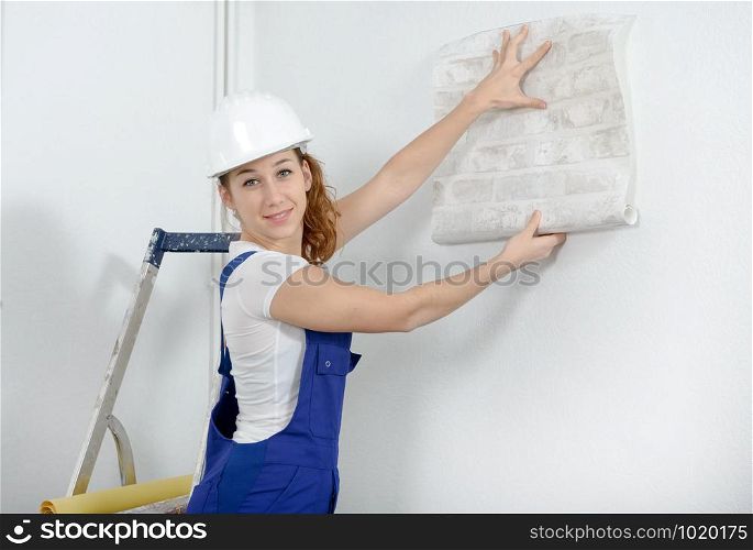 a young woman with roll of wallpaper
