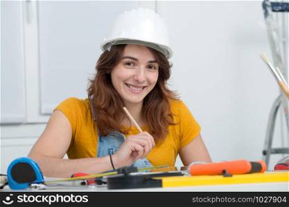 a young woman with safety helmet at office