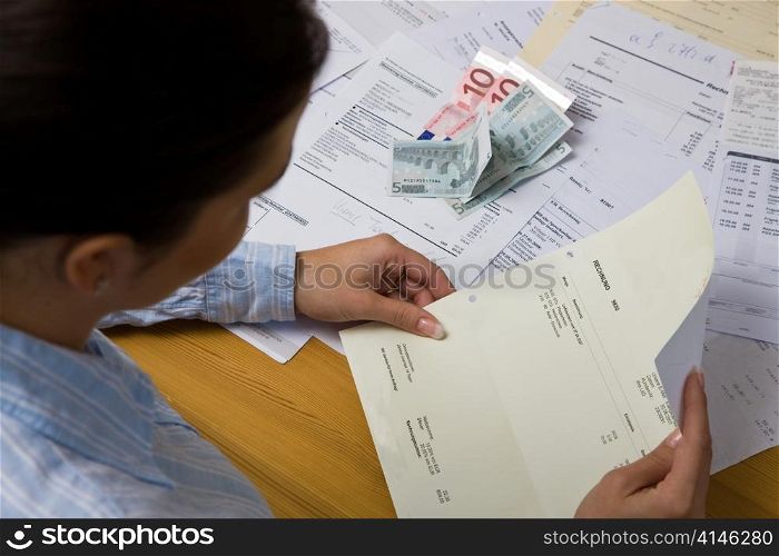 a young woman with unpaid bills. despair because of debts.