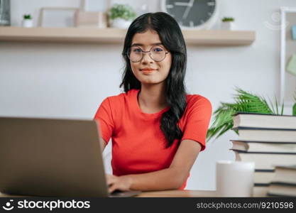 A young woman working with a laptop on the table.