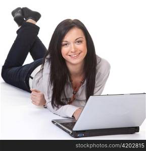 a young woman writes on a laptop computer