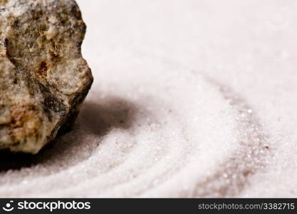 A zen rock garden background with white sand.