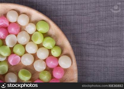 Aalaw or Alua, Thai traditional candy sweet dessert in plate on wood table background