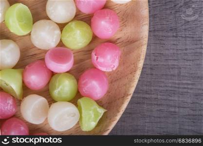 Aalaw or Alua, Thai traditional candy sweet dessert in plate on wood table background