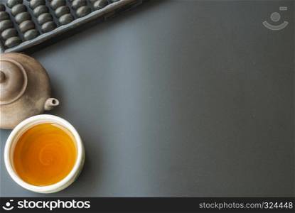 Abacus and Chinese tea set placed on a black table during breaks to drink tea