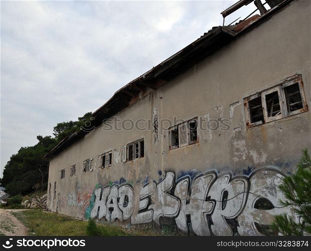 Abandoned and derelict old factory with garbage and graffiti