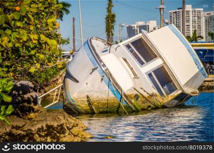abandoned boat rotting in water