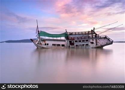 Abandoned boat with beautiful sky in sunrise ,thailand