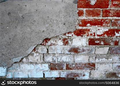 Abandoned brick wall half coverd with cracked plaster, shot with copyspace. Old brick wall half coverd with cracked plaster, copyspace