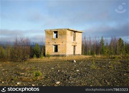 Abandoned building military ground control point range against the background of an autumn forest