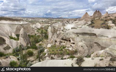 Abandoned caves in the Cappadocia mountains against the blue sky. Abandoned caves in the mountains of Cappadocia
