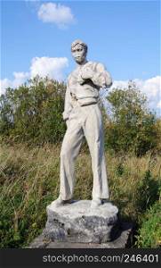 Abandoned destroyed statue of young man in Fedovo village, Arkhangelsk region, Russia. The legacy of the Soviet Union.