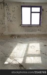 Abandoned empty room with window and light from it