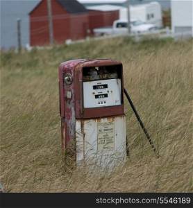 Abandoned fuel pump in grass, Plate Cove East, Bonavista Peninsula, Newfoundland And Labrador, Canada