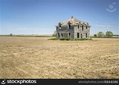 abandoned house in rural Nebraska. rural Nebraska landscape - abandoned old house in the middle of a field