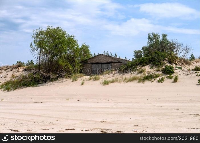 Abandoned house on the sand. House on the beach. Wooden house on the dune.. House on the beach. Abandoned house on the sand. Wooden house on the dune.