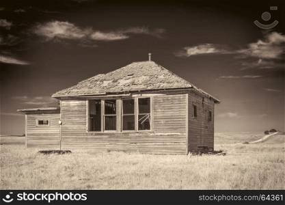 abandoned old house in Nebraska Sandhills, sepia toned image