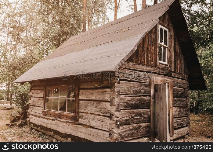 Abandoned old wooden house Cabin in the woods. View of old weathered wooden