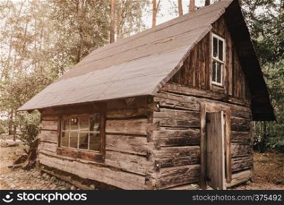 Abandoned old wooden house Cabin in the woods. View of old weathered wooden