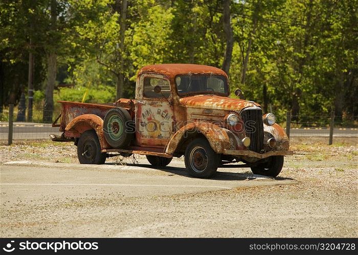 Abandoned pick-up truck parked on a field