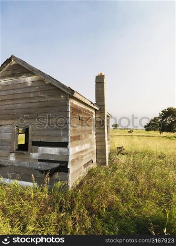 Abandoned rural wooden house in state of disrepair.