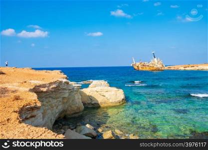 Abandoned rusty ship wreck EDRO III in Pegeia, Paphos, Cyprus. It is stranded on Peyia rocks at kantarkastoi sea caves, Coral Bay, Pafos, standing at an angle near the shore.