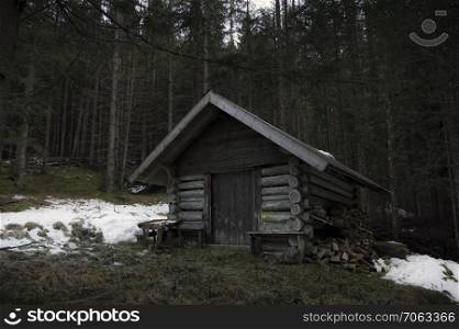 Abandoned wooden cottage in the middle of the austrian forest, near the village Ehrwald, on a cold day of december