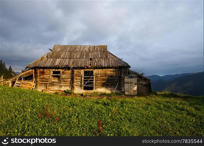 Abandoned wooden house at mountain hill
