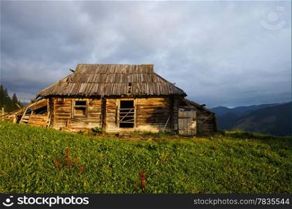 Abandoned wooden house at mountain hill
