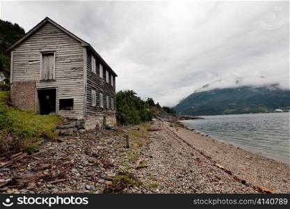 Abandoned wooden house at the coast, Hardanger, Hardangerfjord, Hardangervidda, Hardanger, Norway
