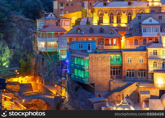 Abanotubani district at night, Tbilisi, Georgia.. Amazing View of famous colorful houses and balconies in old historic district Abanotubani in night Illumination during morning blue hour, Tbilisi, Georgia.