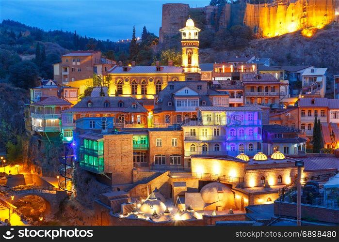Abanotubani district at night, Tbilisi, Georgia.. Amazing View of Jumah Mosque, Sulphur Baths and famous colorful balconies in old historic district Abanotubani in night Illumination during morning blue hour, Tbilisi, Georgia.