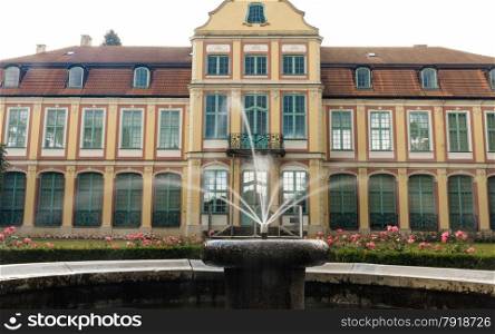 abbots palace landmark in gdansk danzig oliva park poland. famous building with fountain in garden. historical residence house.