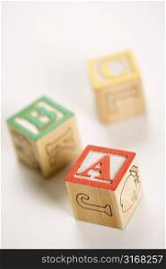 ABC alphabet blocks scattered on white background.