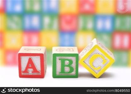 ABC blocks on a colorful blurred background