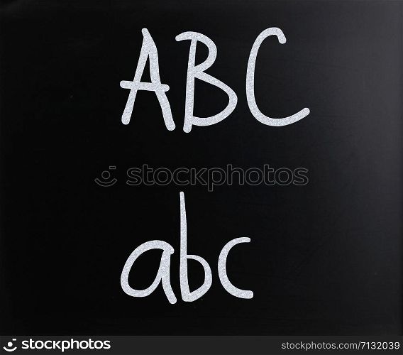 ""ABC" handwritten with white chalk on a blackboard"