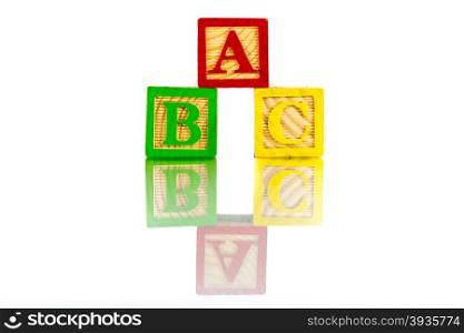 abc letter blocks reflection on white background