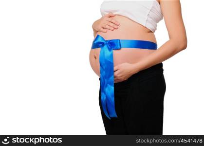 Abdomen a young pregnant woman tied with a ribbon