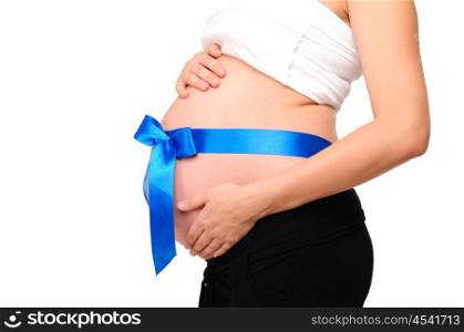 Abdomen a young pregnant woman tied with a ribbon