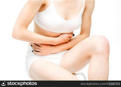 Abdominal pain, female person with stomach problem, white background. Woman in white lingerie, medical advertising or concept. Abdominal pain, female person with stomach problem
