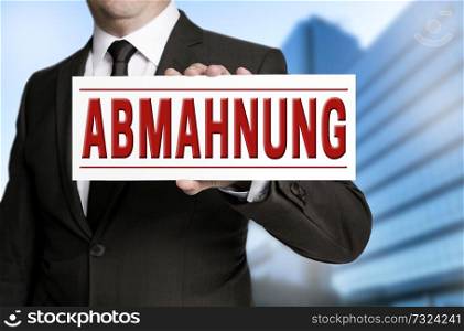 abmahnung (in german warning) sign is held by businessman.. abmahnung (in german warning) sign is held by businessman